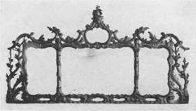 An elaborately carved and gilded Chippendale mantel
 mirror, showing French influence.
