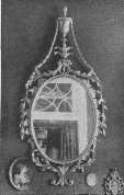 This group of old mirrors indicates the extent to which
refinement of design was carried during the Georgian period in
England—the time of the great cabinet-makers.
