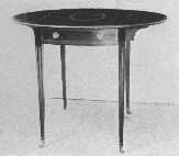 Pembroke tables were made by Hepplewhite. This is a fine
example and shows characteristic inlay and the legs sloping on the
inside edge only. The flaps fold down and make a small oblong table.