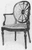 The wheel back design was often used by Adam. The arms,
the curve of the seat and carving, the tapering reeded legs, and the
angle of the back legs should all be noticed.