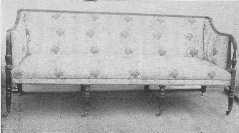 An admirable example of the Sheraton style mahogany
settee with original silk covering.